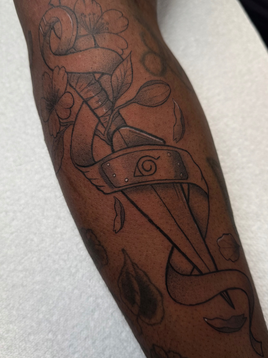 Custom Naruto tattoo on dark skin